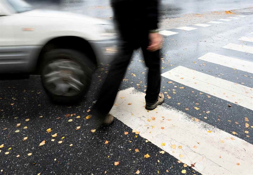 A person walking across a crosswalk
AI-generated content may be incorrect.